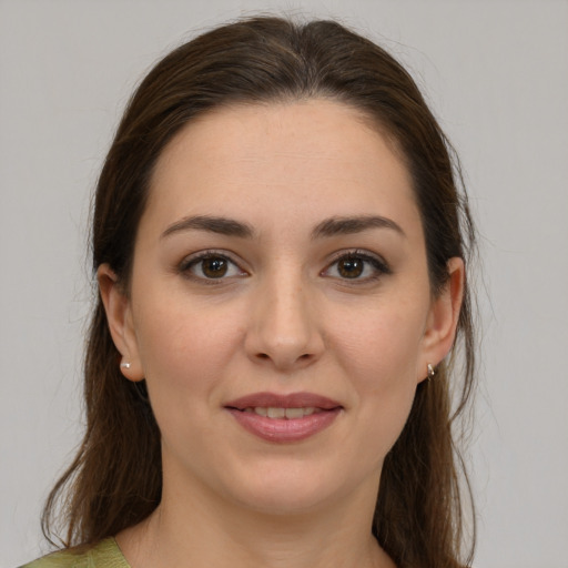 Joyful white young-adult female with medium  brown hair and brown eyes