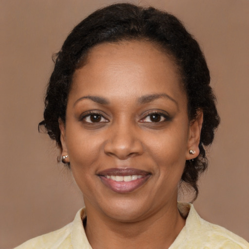 Joyful black young-adult female with medium  brown hair and brown eyes