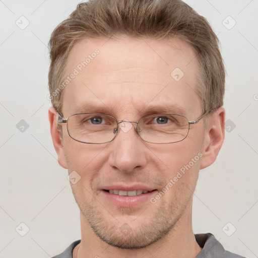 Joyful white adult male with short  brown hair and grey eyes