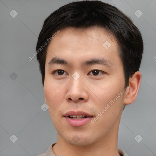 Joyful asian young-adult male with short  brown hair and brown eyes