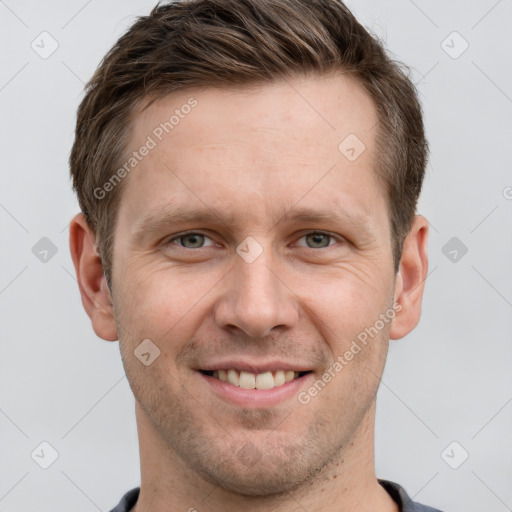 Joyful white adult male with short  brown hair and grey eyes