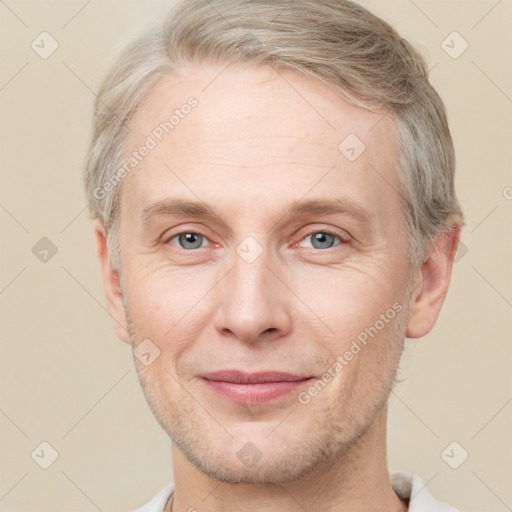 Joyful white adult male with short  brown hair and grey eyes