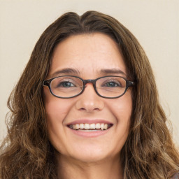 Joyful white young-adult female with long  brown hair and green eyes