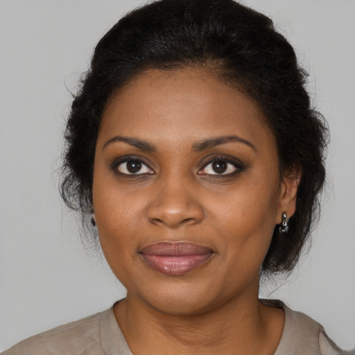 Joyful black young-adult female with medium  brown hair and brown eyes