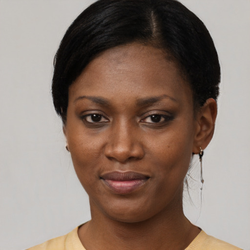 Joyful black young-adult female with short  black hair and brown eyes