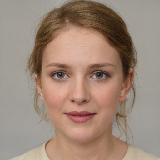 Joyful white young-adult female with medium  brown hair and blue eyes