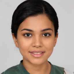 Joyful latino young-adult female with short  brown hair and brown eyes