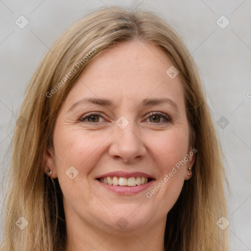 Joyful white adult female with long  brown hair and brown eyes