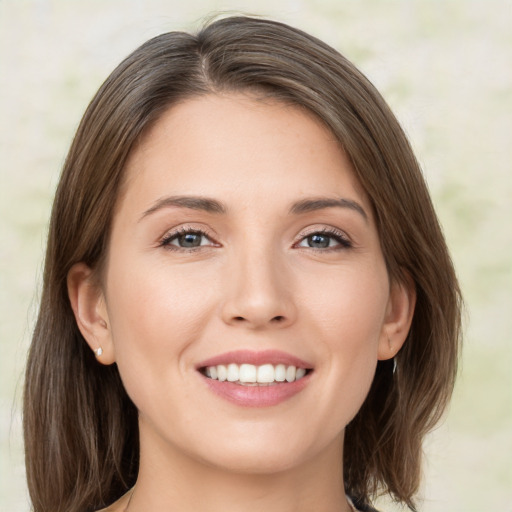 Joyful white young-adult female with medium  brown hair and green eyes