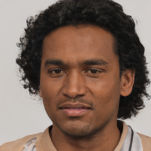 Joyful black young-adult male with short  black hair and brown eyes