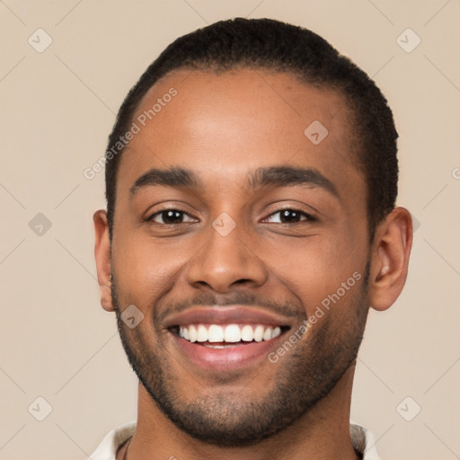 Joyful black young-adult male with short  brown hair and brown eyes