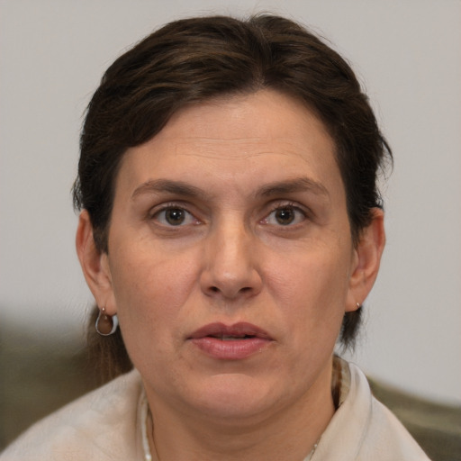 Joyful white adult female with short  brown hair and brown eyes