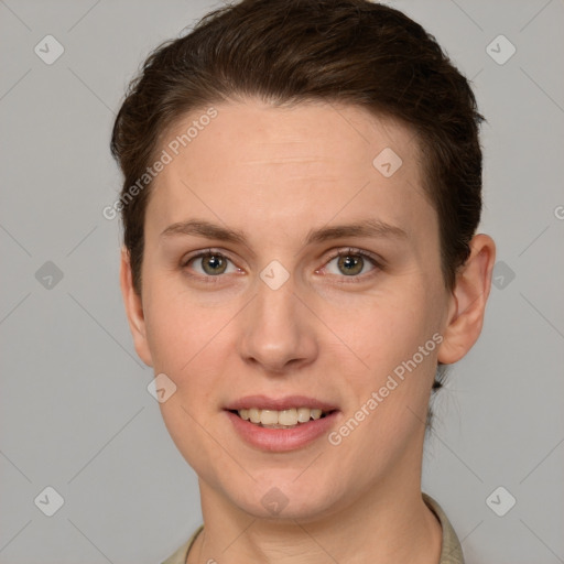 Joyful white young-adult female with short  brown hair and grey eyes