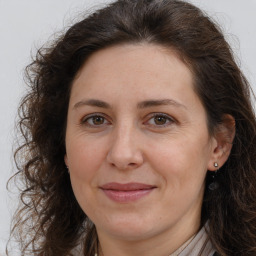 Joyful white adult female with long  brown hair and brown eyes