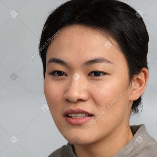 Joyful asian young-adult female with short  black hair and brown eyes