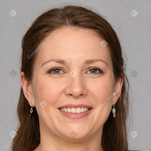 Joyful white adult female with long  brown hair and grey eyes