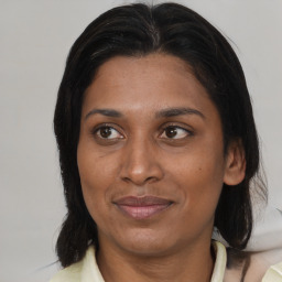 Joyful asian adult female with medium  brown hair and brown eyes