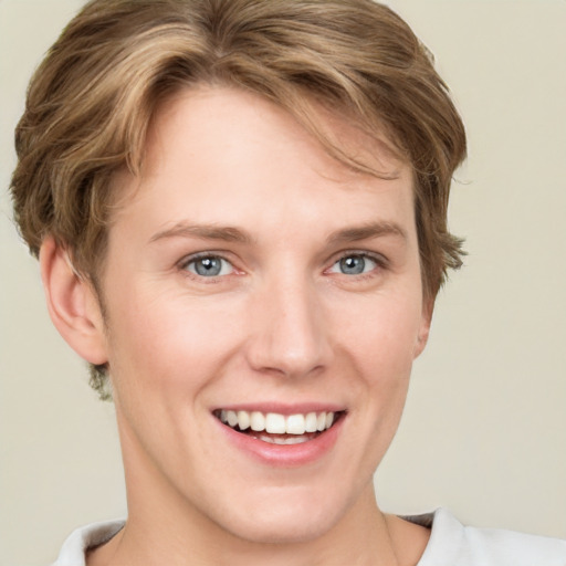 Joyful white young-adult female with short  brown hair and grey eyes