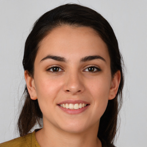 Joyful white young-adult female with medium  brown hair and brown eyes