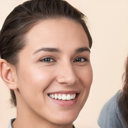 Joyful white young-adult female with medium  brown hair and brown eyes