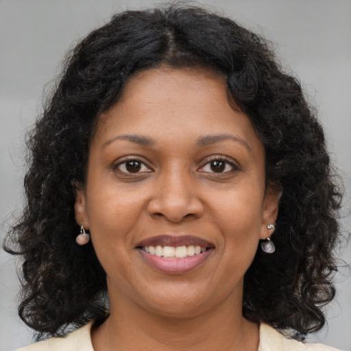 Joyful black young-adult female with medium  brown hair and brown eyes