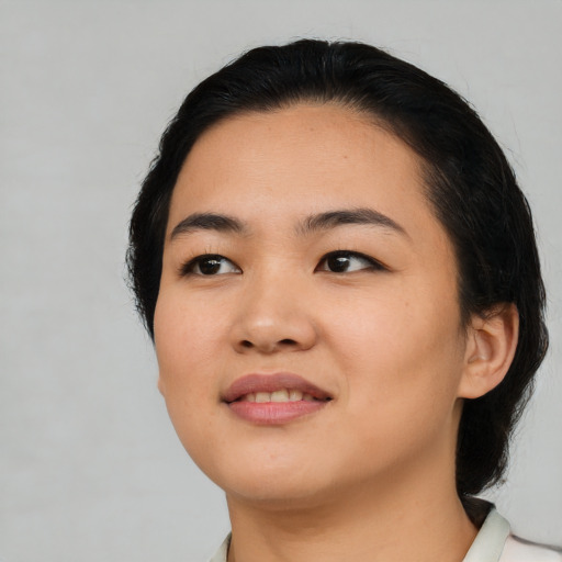 Joyful asian young-adult female with medium  black hair and brown eyes