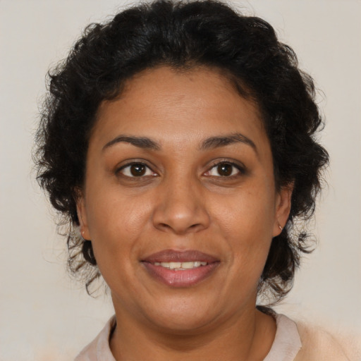 Joyful latino adult female with short  brown hair and brown eyes