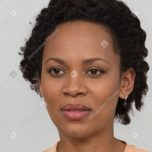 Joyful black adult female with medium  brown hair and brown eyes