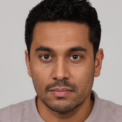 Neutral latino young-adult male with short  black hair and brown eyes