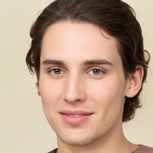 Joyful white young-adult male with medium  brown hair and brown eyes