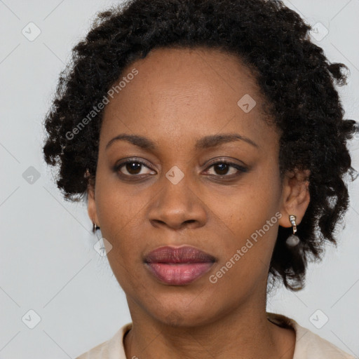 Joyful black adult female with medium  brown hair and brown eyes