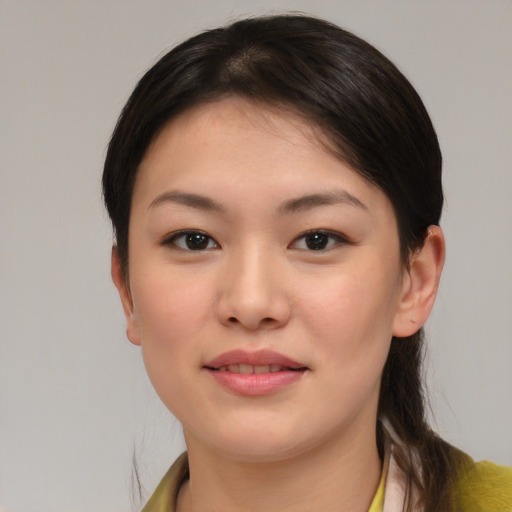 Joyful white young-adult female with medium  brown hair and brown eyes