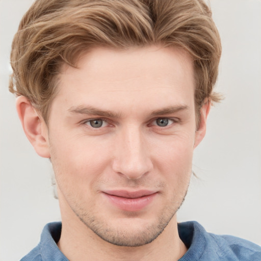 Joyful white young-adult male with short  brown hair and blue eyes