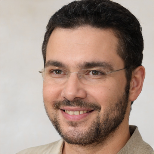 Joyful white adult male with short  brown hair and brown eyes