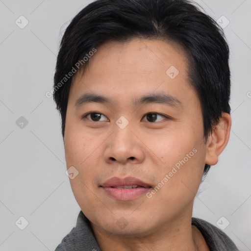 Joyful asian young-adult male with short  brown hair and brown eyes