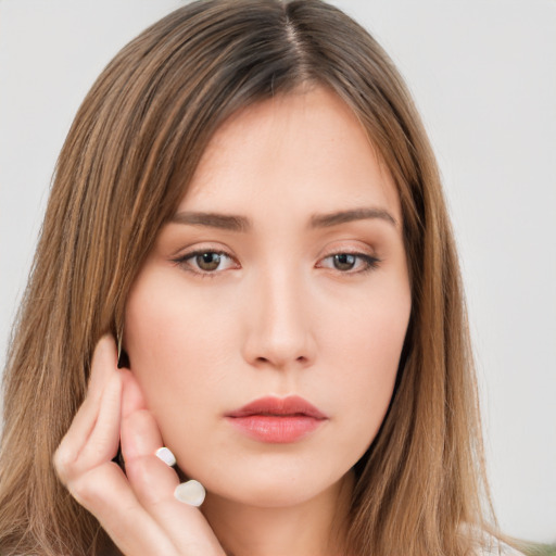 Neutral white young-adult female with long  brown hair and brown eyes