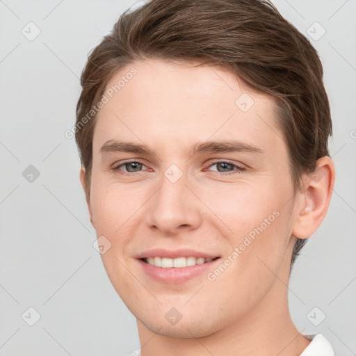 Joyful white young-adult female with short  brown hair and grey eyes