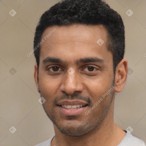 Joyful black young-adult male with short  black hair and brown eyes