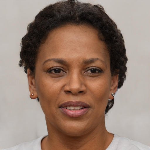 Joyful black adult female with short  brown hair and brown eyes