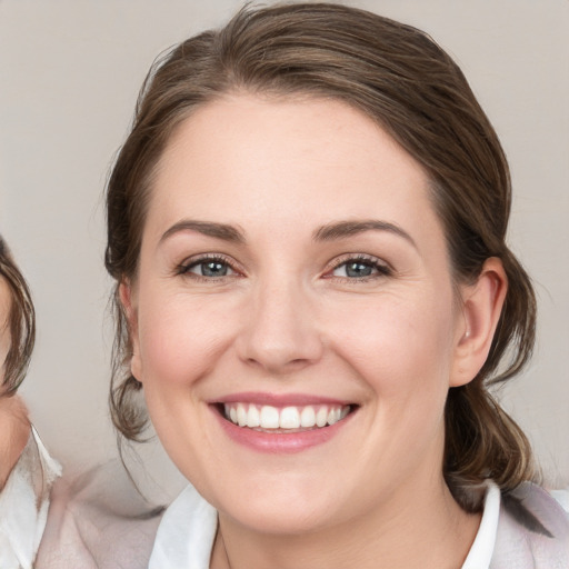 Joyful white young-adult female with medium  brown hair and blue eyes