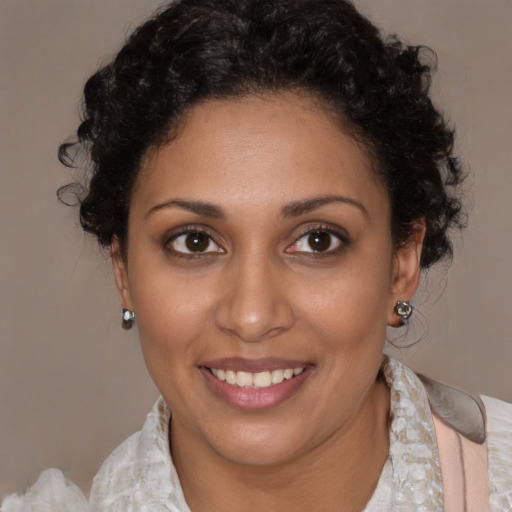 Joyful black young-adult female with medium  brown hair and brown eyes