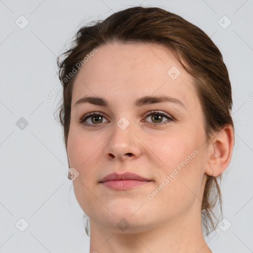 Joyful white young-adult female with medium  brown hair and grey eyes