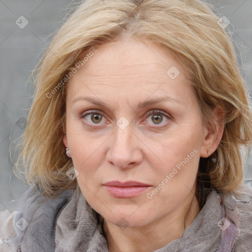 Joyful white adult female with medium  brown hair and blue eyes