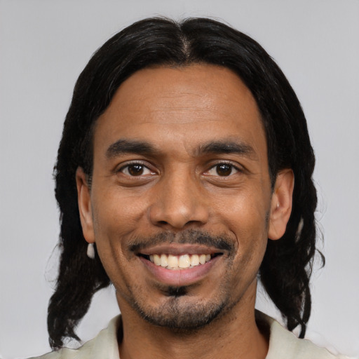 Joyful black young-adult male with medium  black hair and brown eyes