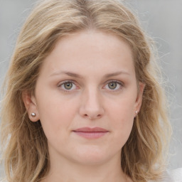 Joyful white young-adult female with long  brown hair and blue eyes