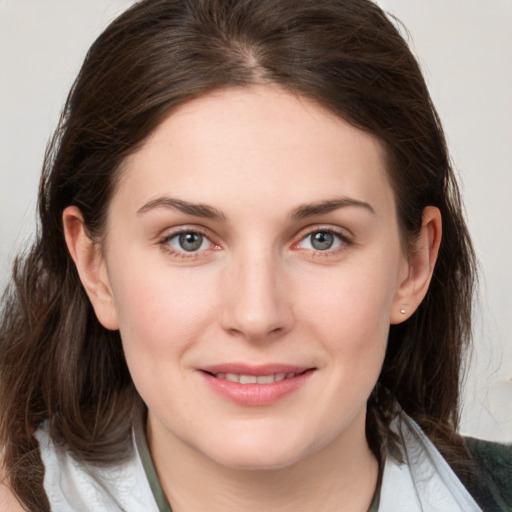 Joyful white young-adult female with medium  brown hair and grey eyes