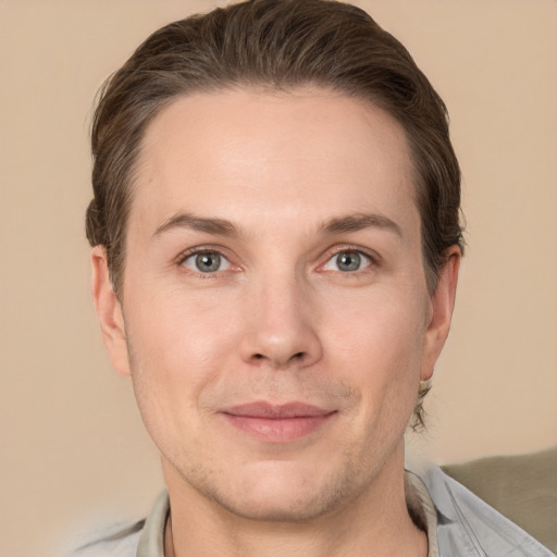 Joyful white adult male with short  brown hair and grey eyes