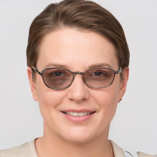 Joyful white young-adult female with short  brown hair and grey eyes