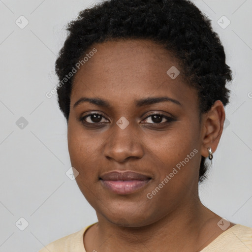 Joyful black young-adult female with short  black hair and brown eyes