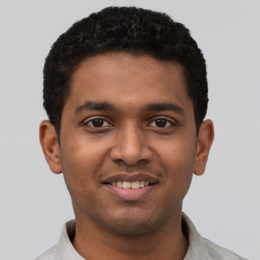 Joyful black young-adult male with short  black hair and brown eyes